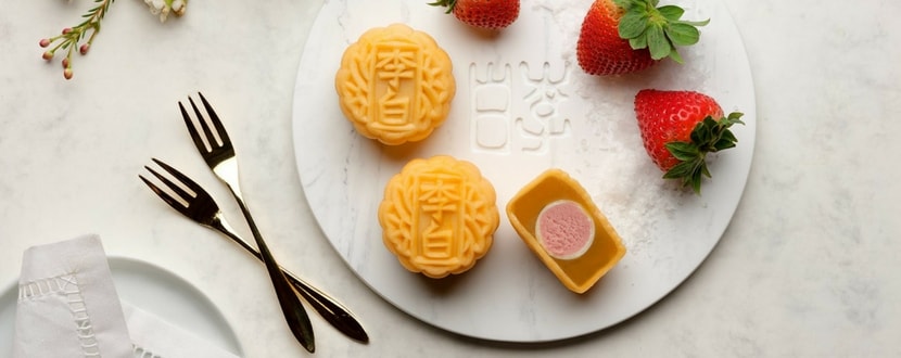 mooncakes and strawberries on a white plate