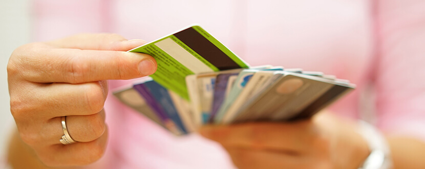 person arranging credit cards in hand -SingSaver